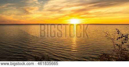 Fiery Orange Sunset Sky. Countryside Landscape Under Scenic Colorful Sky At Sunset Dawn Sunrise. Sun