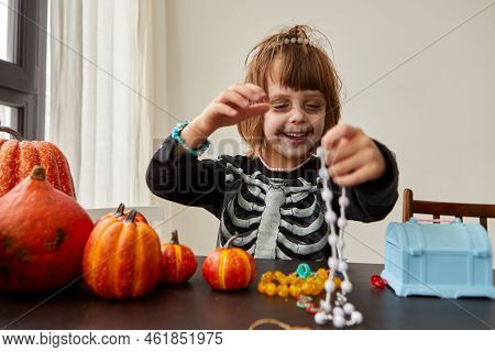 Happy Child Dressing Up With Decorations Before Halloween Holiday