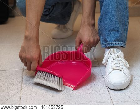 Home Cleaning Concept.  Brooming Floor Using A Whisk Broom And Dustpan. Man's Hands.