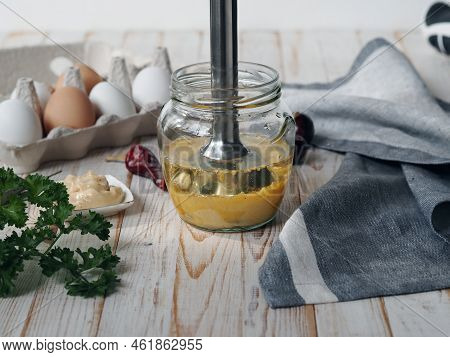 The Concept Of Making Mayonnaise At Home. A Jar With Ready Made Mayonnaise, Vegetable Oil, Eggs And 