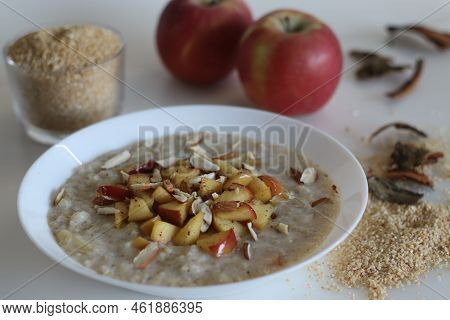 Broken Wheat Or Dalia Porridge. Porridge For Breakfast Made With Broken Wheat And Milk, Served With
