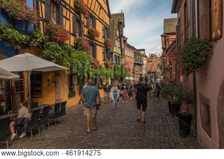 People On Street In Medieval Village Of Riquewihr, Alsace, France