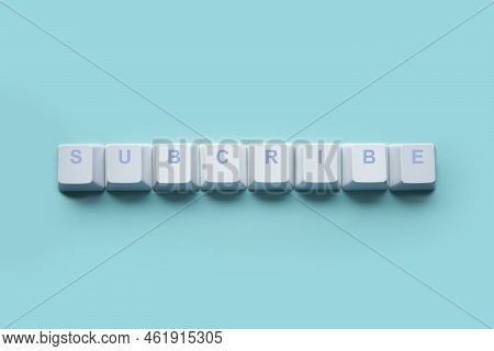 Word Subcribe Written On Computer Keyboard Keys Isolated On A Turquoise Background.