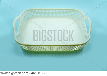 White Plastic Basket With Woven Pattern Isolated On A Turquoise