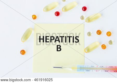 Blue Card With Text Hepatitis B On A Table With A Pills