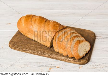 Assortment Of Freshly Sliced Baked Bread With Napkin On Rustic Table Top View. Healthy Unleavened Br