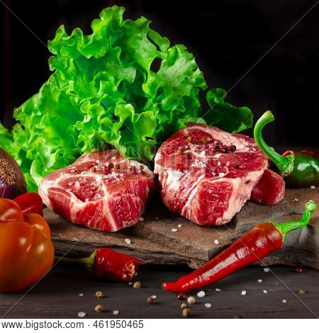 Raw Juicy Pork Steaks And Fresh Vegetables Before Cooking