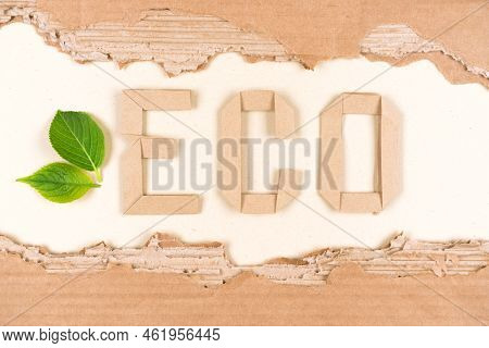 Sustainable Paper Packaging Concept. Text Eco Made With Paper Letters And Sheets Of Corrugated Cardb