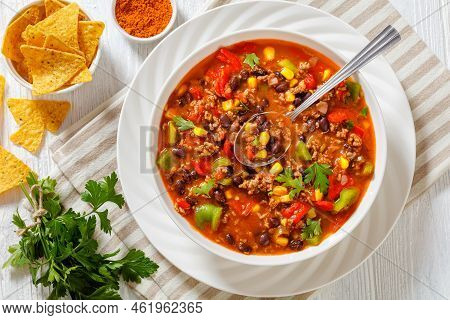 Taco Soup Of Ground Beef, Tomatoes, Chopped Green Chilis, Onions, Corn, Red Beans And Taco Seasoning