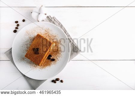 Traditional Italian Dessert Tiramisu On Light Background. Tiramisu Cake Decorated With Coffee Beans.