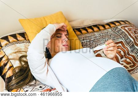 Pregnancy Health Temperature Check. Pregnant Woman Holding Thermometer, Check Fever Flu Temperature.