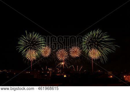 Green And Yellow Fireworks In A Night Sky