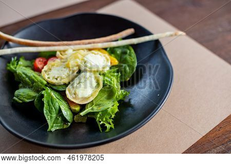 Breakfast In The Morning, Creamy Omelet And Buratta Chesese, Salad Avocado And Green Leaves On Black