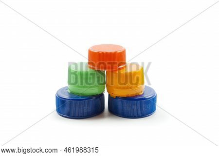 Colorful Plastic Bottle Caps Including Recyclable Materials Isolated On A White Background.