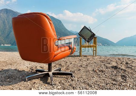 vintage decor on the lake shore, armchair and television