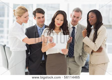 Business team looking at document together in the office