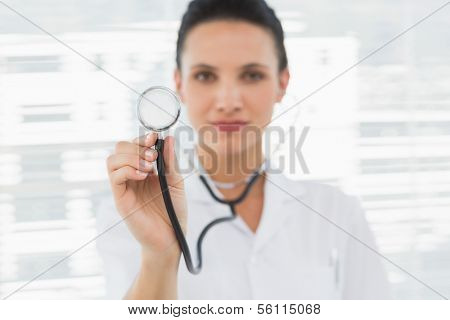 Portrait of a female doctor with stethoscope in a bright hospital