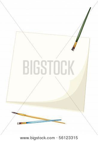 Artist Brushes Lying On A Blank Sketchbook