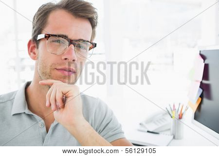 Portrait of a serious casual male photo editor in a bright office