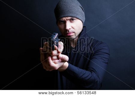 Portrait of a man holding gun