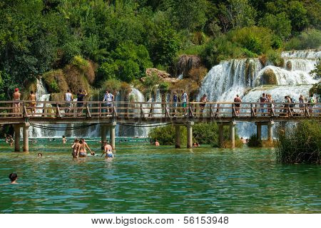 KRKA NATIONAL PARK, CROATIA - JUL 28: Tourists swimming, taking photos and walking on July 28, 2012 on Krka National Park, Croatia. One of most famous Croatian tourist attraction. 