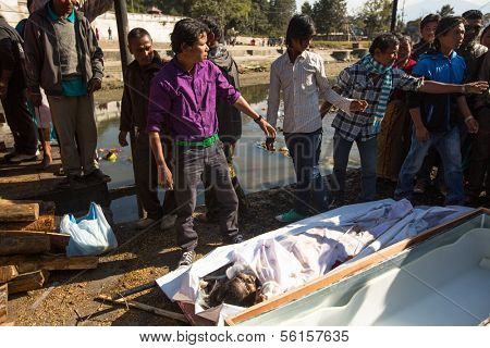 KATHMANDU, NEPAL - DEC 3: Unidentified local people during the cremation ceremony along the holy Bagmati River in Bhasmeshvar Ghat at Pashupatinath temple, Dec 3, 2013 in Kathmandu, Nepal.