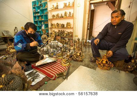 BHAKTAPUR, NEPAL - DEC 5: Unidentified Nepalese tinman working in the his workshop, Dec 5, 2013 in Bhaktapur, Nepal. 100 cultural groups have created an image Bhaktapur as Capital of Nepal Arts.