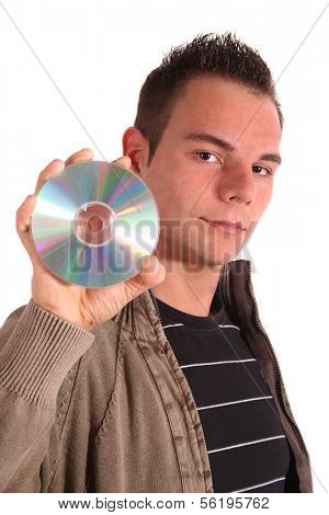 A handsome teenager holding a cd oder dvd. All isolated on white background.