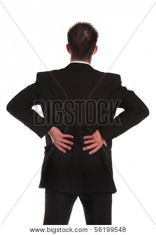 A businessman suffering from backache. All on white background.