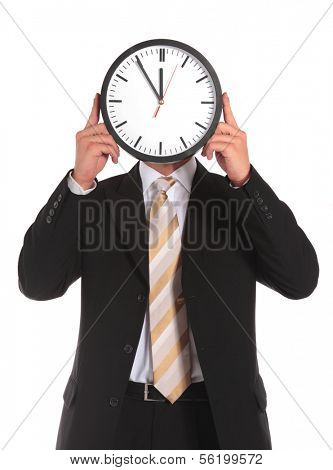 A businessman holding a clock that shows the elventh hour right in front of his face. All on white background.