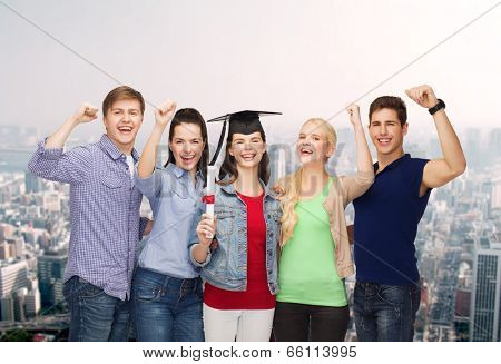 education and people concept - group of standing smiling students with diploma and corner-cap