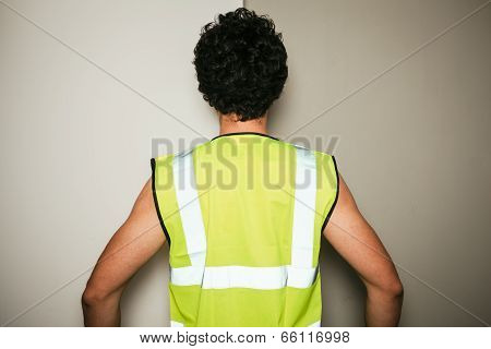 Rear View Of Builder In High Visibility Vest