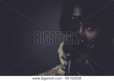 Gunfire, paintball sport player wearing protective helmet aiming pistol ,black armor and machine gun