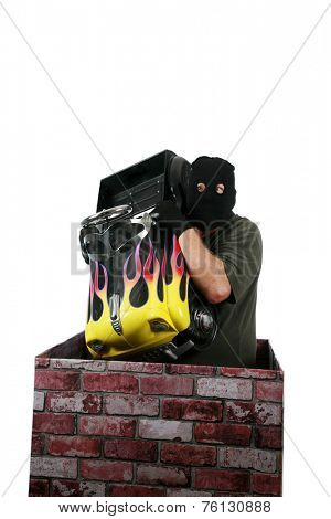 A genuine Bad Guy aka Burglar pops his head out of a chimney looking to see if the coast is clear for his escape after robbing money and valuables from a persons home. Burglars are cowardly thief's 