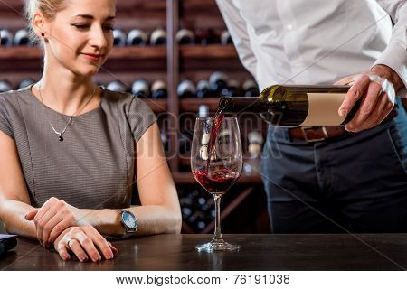 Sommelier with young woman on degustation in the cellar