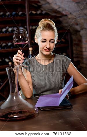 Woman tasting wine in the cellar