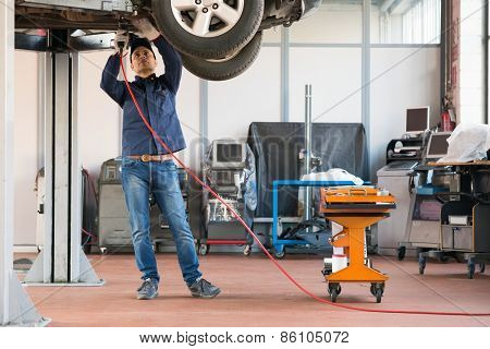 Portrait of a mechanic at work in his garage
