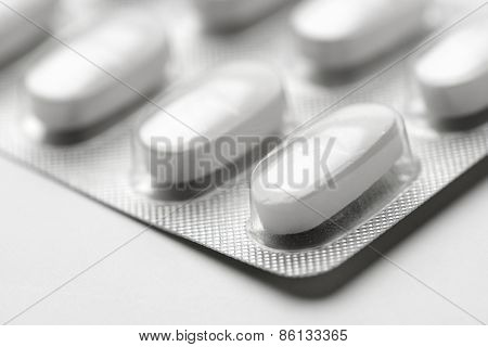 Forefront of a white medicine pills in blister pack.