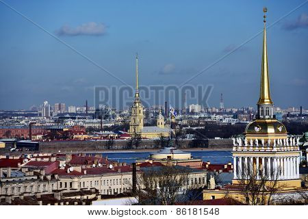 ST. PETERSBURG, RUSSIA - MARCH 5, 2015: Cityscape viewed from the St. Isaac's Cathedral with the spire of Admiralty and the spire of the Peter and Paul Cathedral. It is two most famous spires of city
