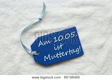 Muttertag Means Mothers Day On Blue Label Sand Background
