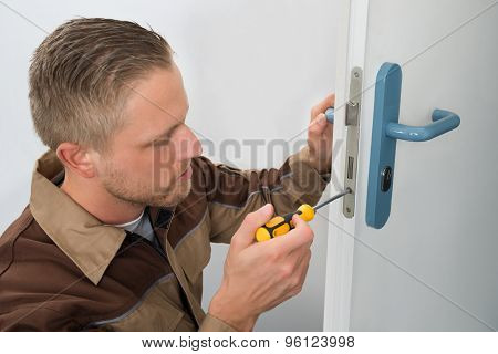 Carpenter Repairing Door Lock