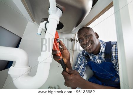 Handyman Repairing Sink Pipe