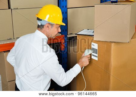 Manager Scanning Cardboard Box With Barcode Scanner