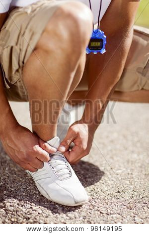 Fit Man Tying His Shoes