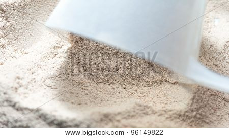 Isolate Protein Powder Chocolate Deluxe Flavour With Scoop Macro Closeup