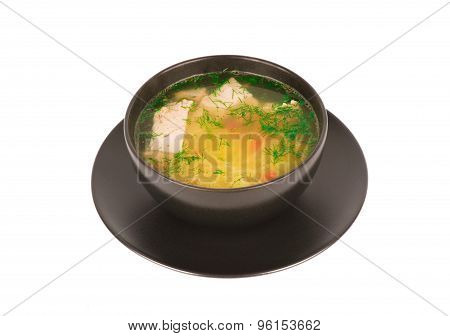 Chicken soup in the black bowl isolated.