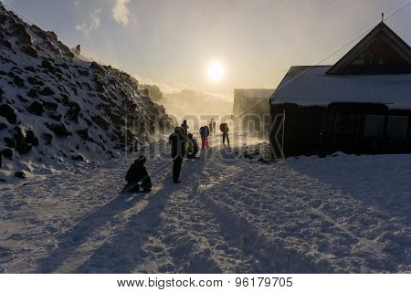 Unrecognisable people protect themselves and play backlit by fading sun