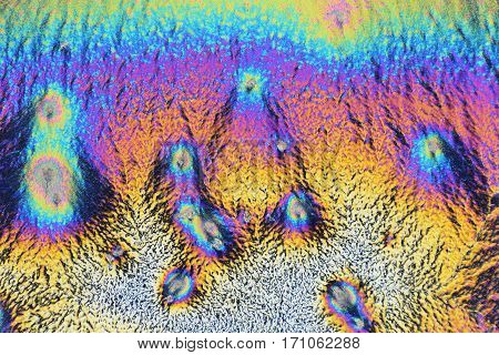Colorful micro crystals through the microscope in polarized light