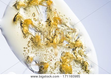 Macro detail of liquid cannabis oil extraction aka shatter with bubbles - medical marijuana concept