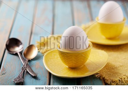 Boiled eggs served from yellow cups